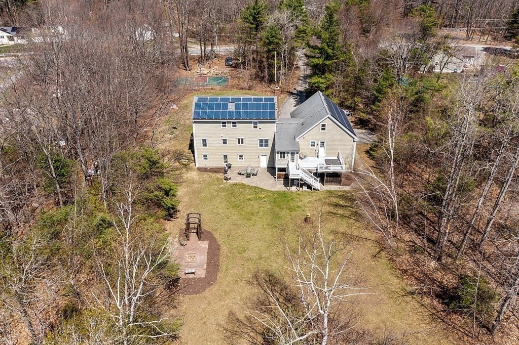 258 West Road Ashby, MA 01431 - Photo 39 of 42 a house with tall trees in front of it
