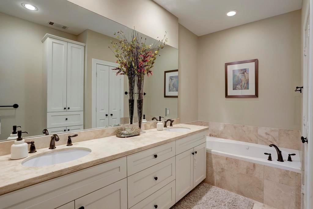 916 Lawrence Street, Unit C Houston, TX 77008 - Photo 26 of 38 a bathroom with a double vanity sink mirror and bathtub
