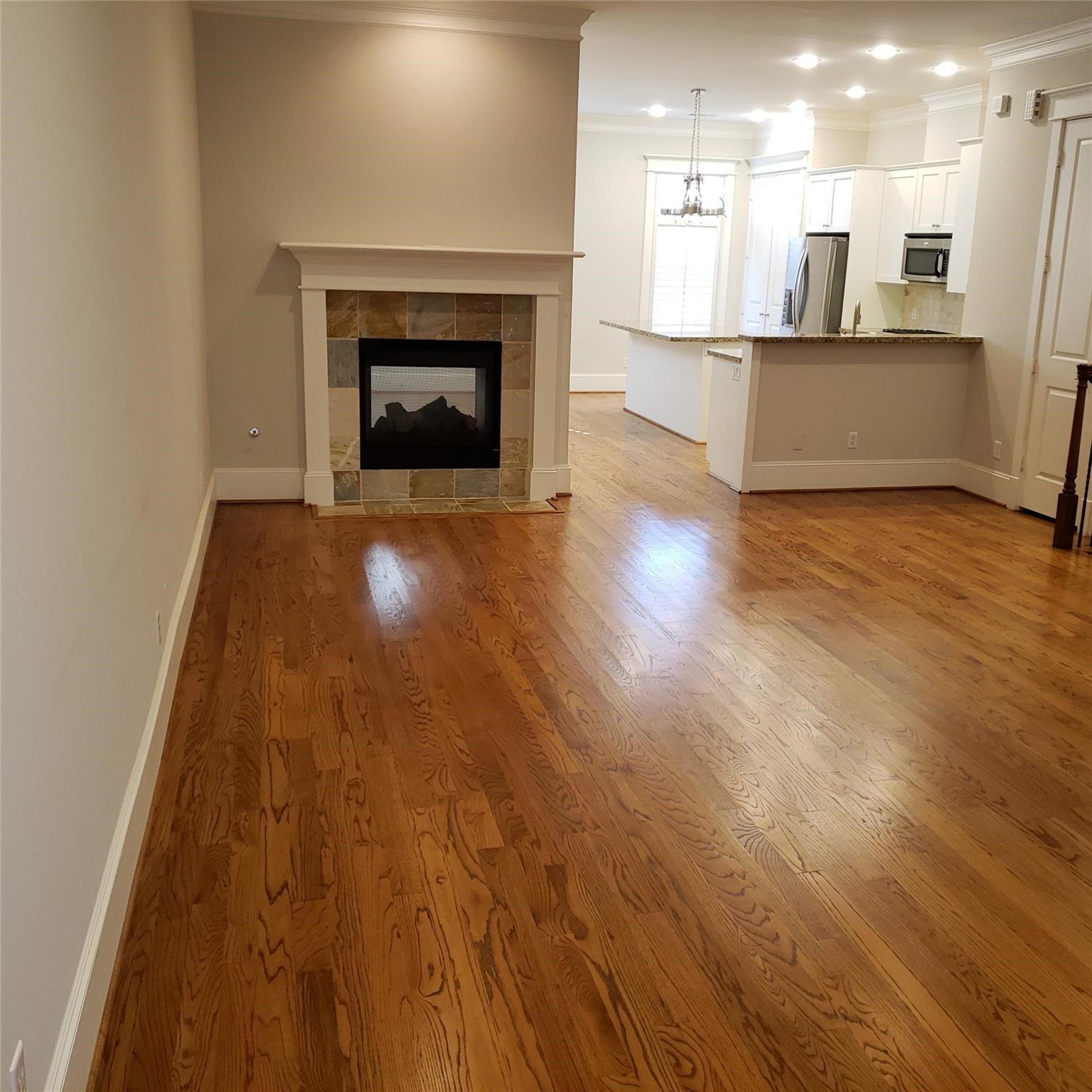 916 Lawrence Street, Unit C Houston, TX 77008 - Photo 4 of 38 a view of kitchen and hall with wooden floor