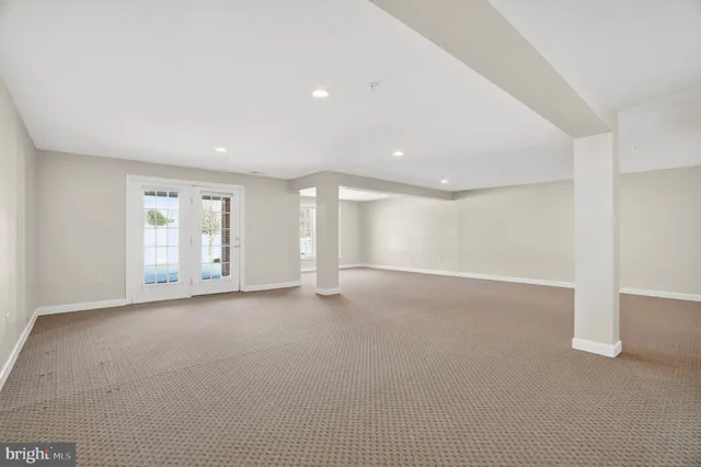 a front view of a house with a yard and potted plants