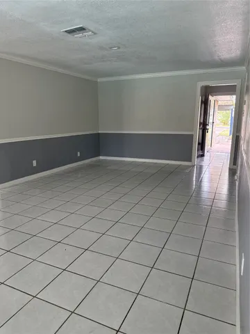 a view of a livingroom with an empty space and a fireplace