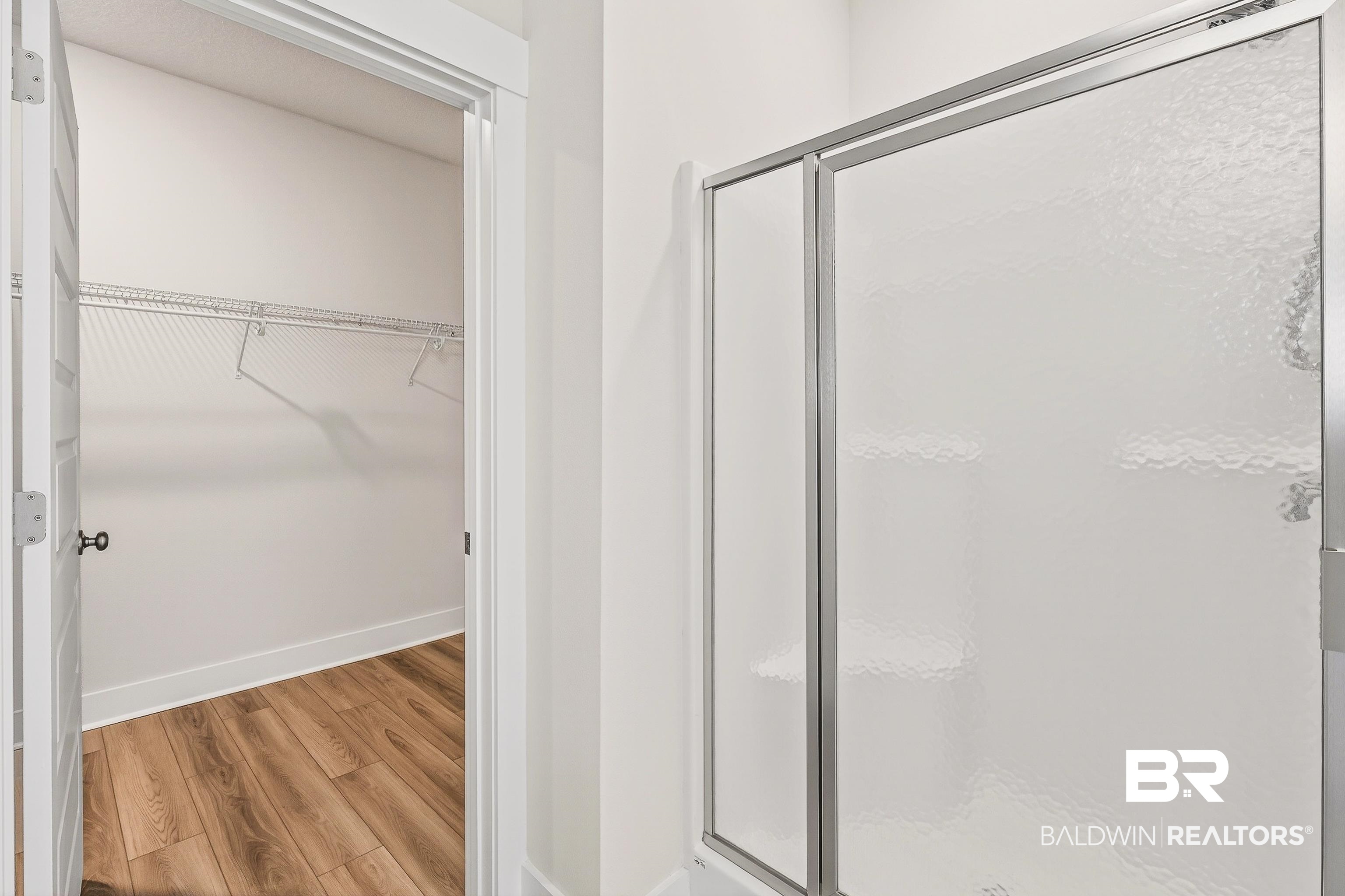 1728 Partridge Street Foley, AL 36535 - Photo 21 of 37 Bathroom featuring a walk in closet, wood finished floors, and a shower stall