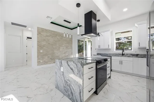 a kitchen with stainless steel appliances granite countertop a stove and a sink