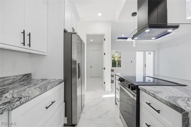 a kitchen with stainless steel appliances granite countertop a sink and a refrigerator