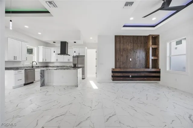 a kitchen with white cabinets and appliances