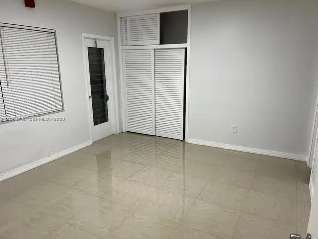 a view of kitchen with refrigerator and window