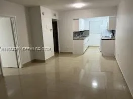 a kitchen with a granite countertop sink and cabinets