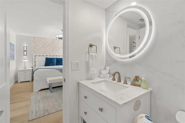 a utility room with dryer washer and a view of bathroom