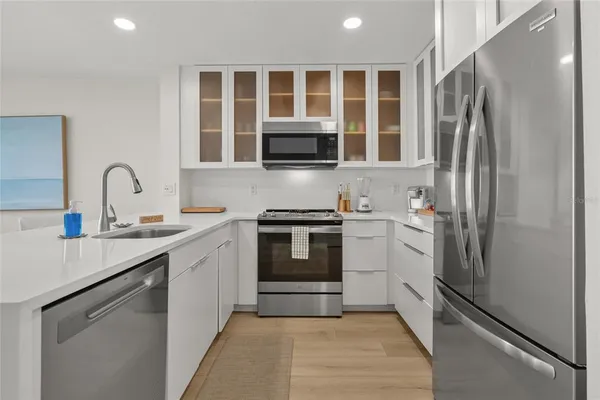 a kitchen with a refrigerator stove and sink