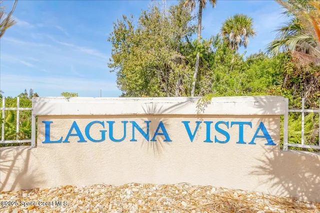 a view of multiple houses with a yard