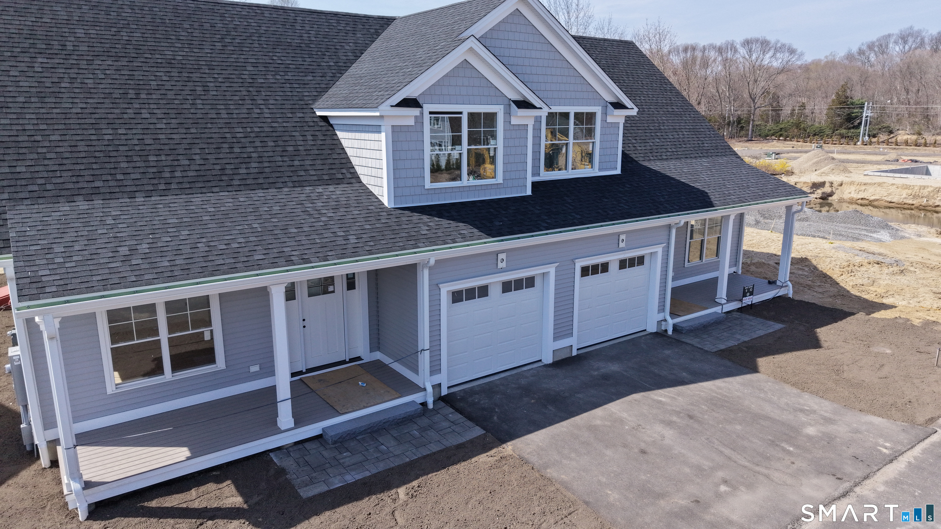 151-153 East Main Street, Unit 19 Clinton, CT 06413 - Photo 20 of 34 a front view of a house with a garage