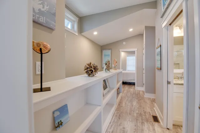 a view of a kitchen with a sink and wooden floor