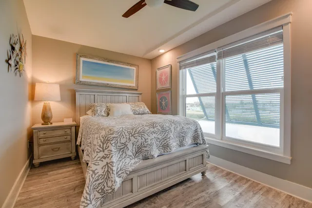 a bedroom with a large bed and a large window