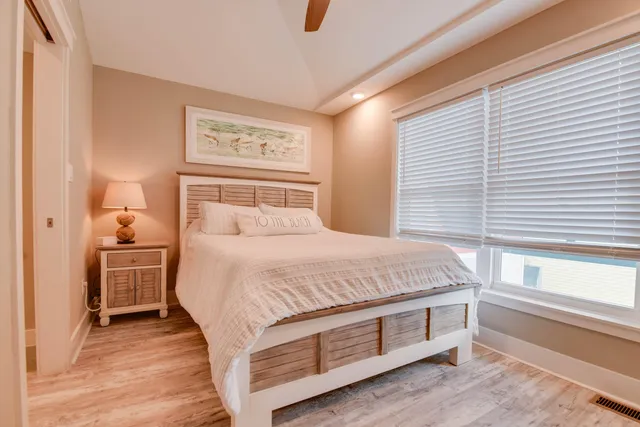 a bed sitting in a bedroom next to a window