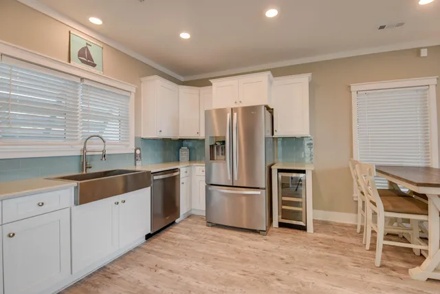 a kitchen with granite countertop a refrigerator and a sink