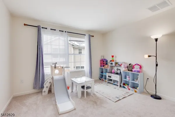 a living room with furniture a desk and chair