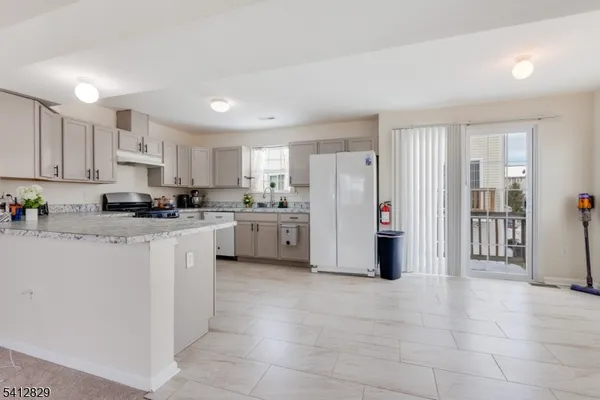 a kitchen with stainless steel appliances a refrigerator sink and cabinets