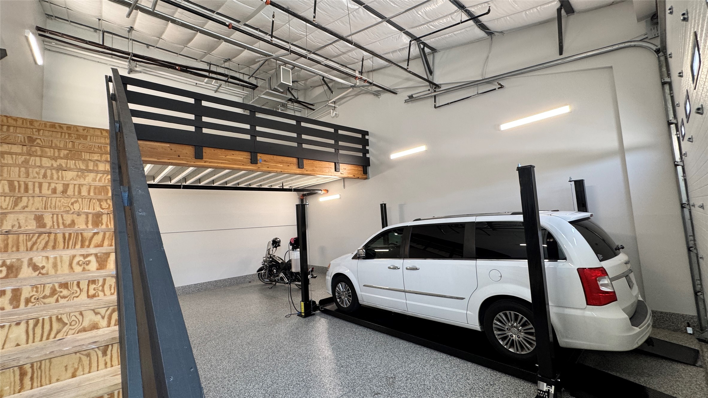 1009 Ranch Road 620 North, Unit 401 Lakeway, TX 78734 - Photo 3 of 15 Secure parking and extra storage space with an integrated car lift and versatile mezzanine.