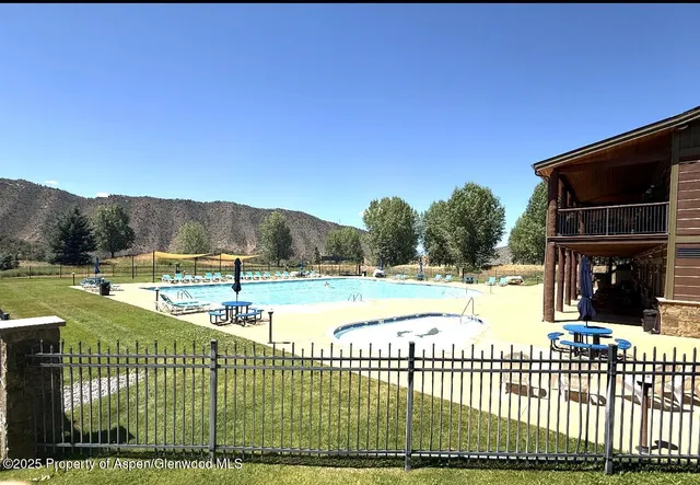 a view of a swimming pool with a yard