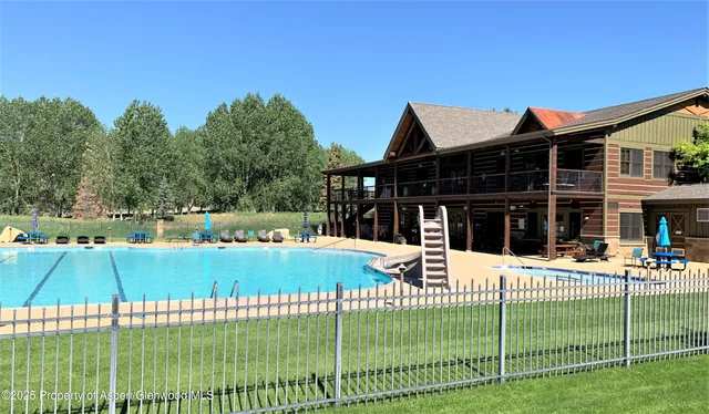 a view of a house with a backyard porch and sitting area
