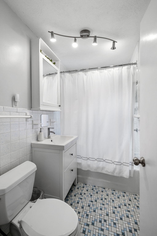 4 Edgewood Road Newton, MA 02465 - Photo 27 of 39 a bathroom with a sink a toilet a shower and a mirror