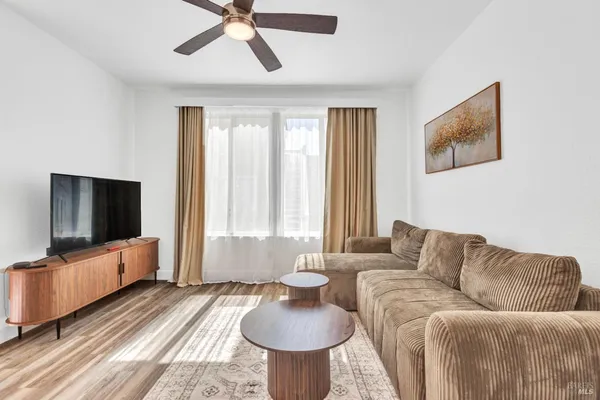 a living room with furniture and a flat screen tv