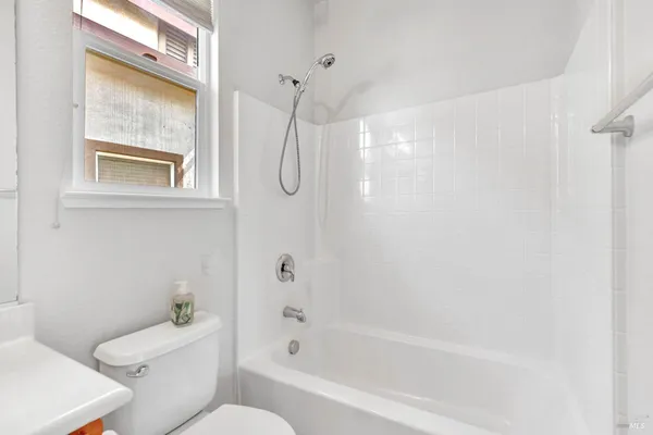 a bathroom with a sink vanity mirror and toilet