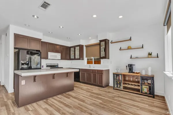 a kitchen with stainless steel appliances granite countertop a sink and stove