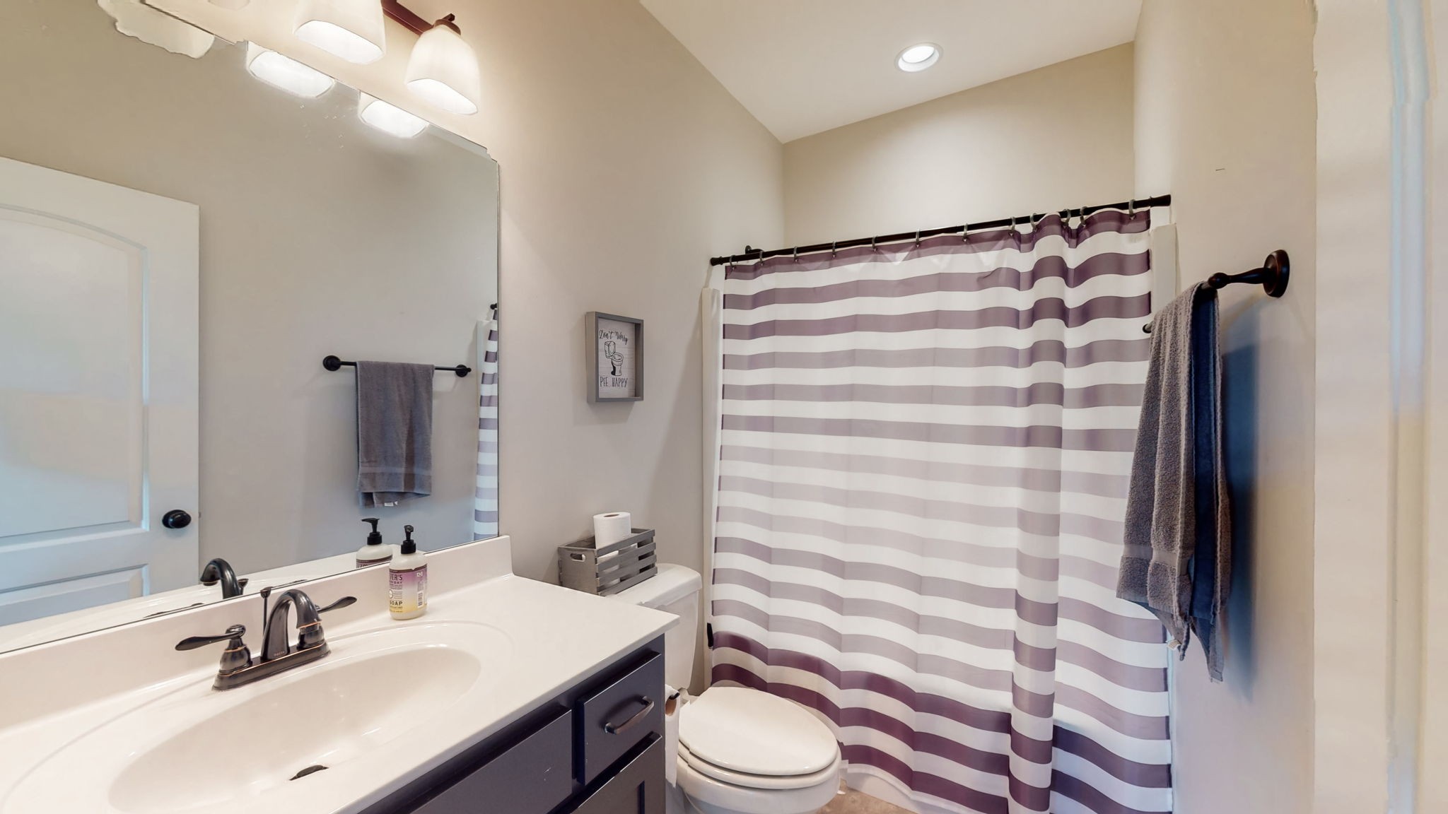 650 Burford Road Lebanon, TN 37087 - Photo 19 of 50 a bathroom with a sink a toilet a mirror and shower curtain
