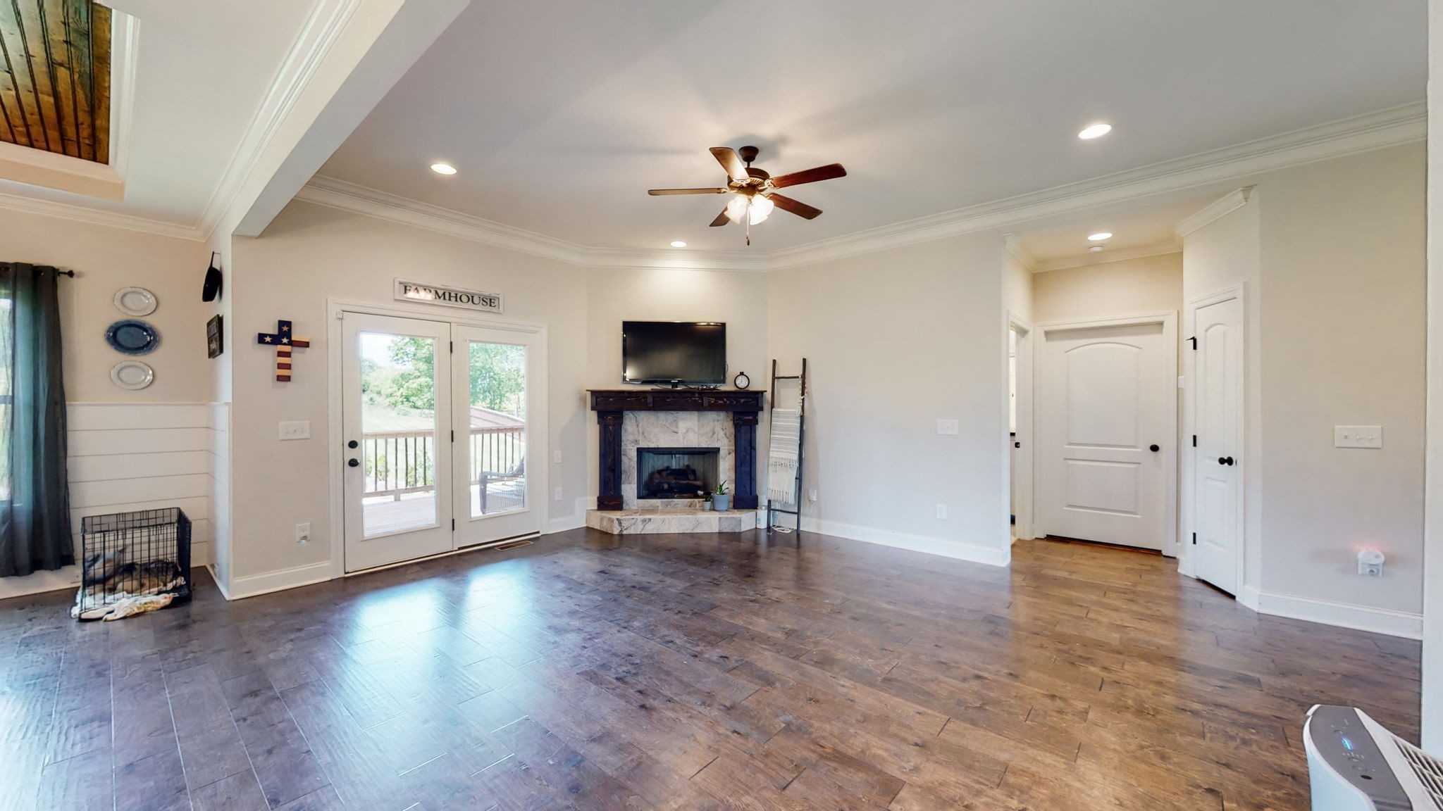 650 Burford Road Lebanon, TN 37087 - Photo 3 of 50 a view of a livingroom with a fireplace a ceiling fan and wooden floor