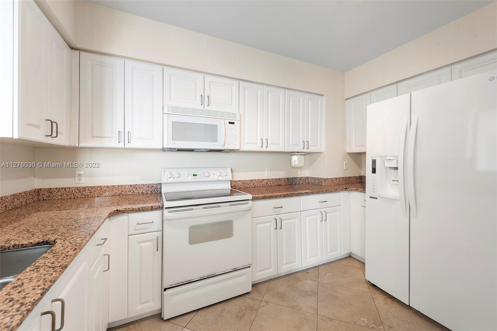 1155 Brickell Bay Drive, Unit PH104 Miami, FL 33131 - Photo 6 of 33 a kitchen with cabinets appliances a sink and a counter top space