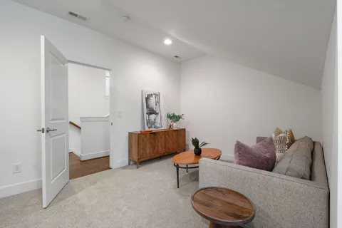 a living room with furniture and a mirror