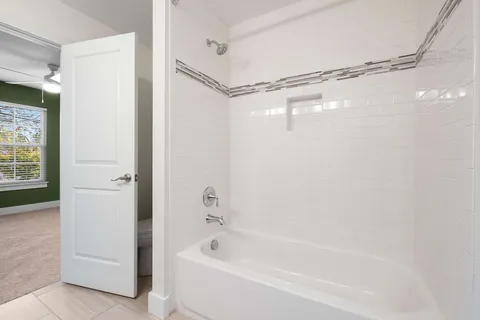 a bathroom with a shower and a tub