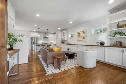 a living room with kitchen island furniture and a kitchen view