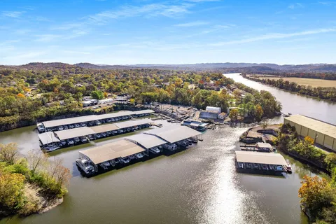 a view of a lake with boats and trees in the background
