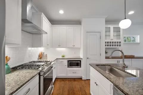 a kitchen with a sink stove and cabinets