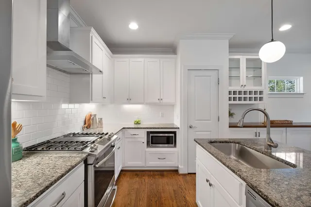 a kitchen with a sink stove and cabinets