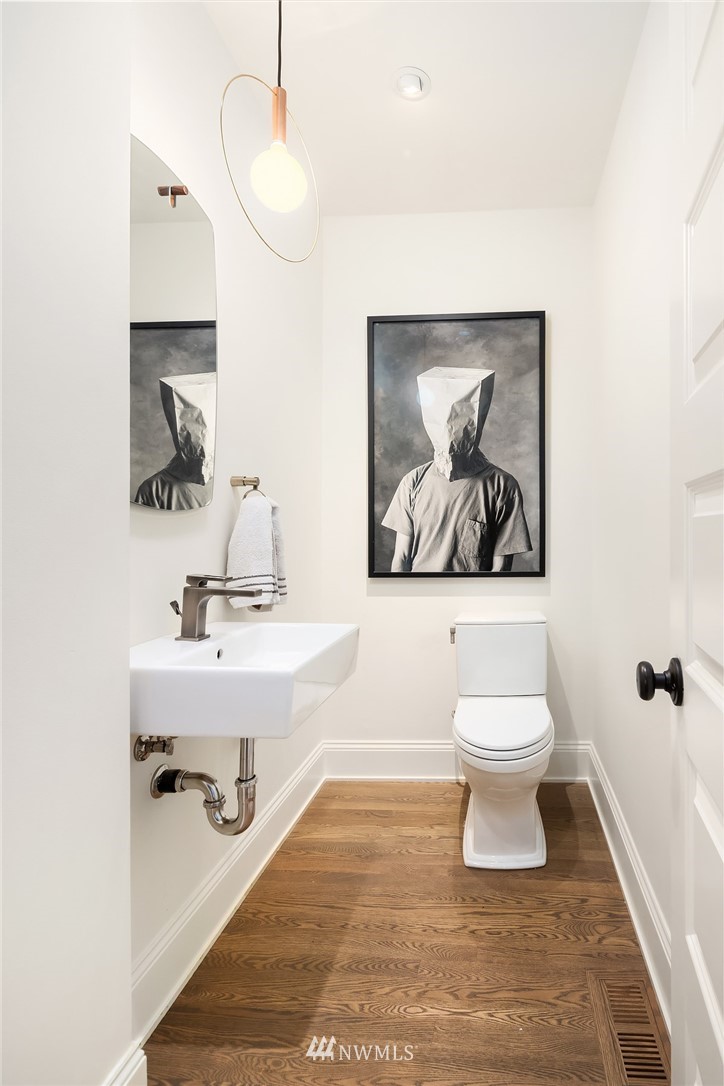 1618 37th Avenue Seattle, WA 98122 - Photo 14 of 39 a bathroom with a toilet sink and mirror