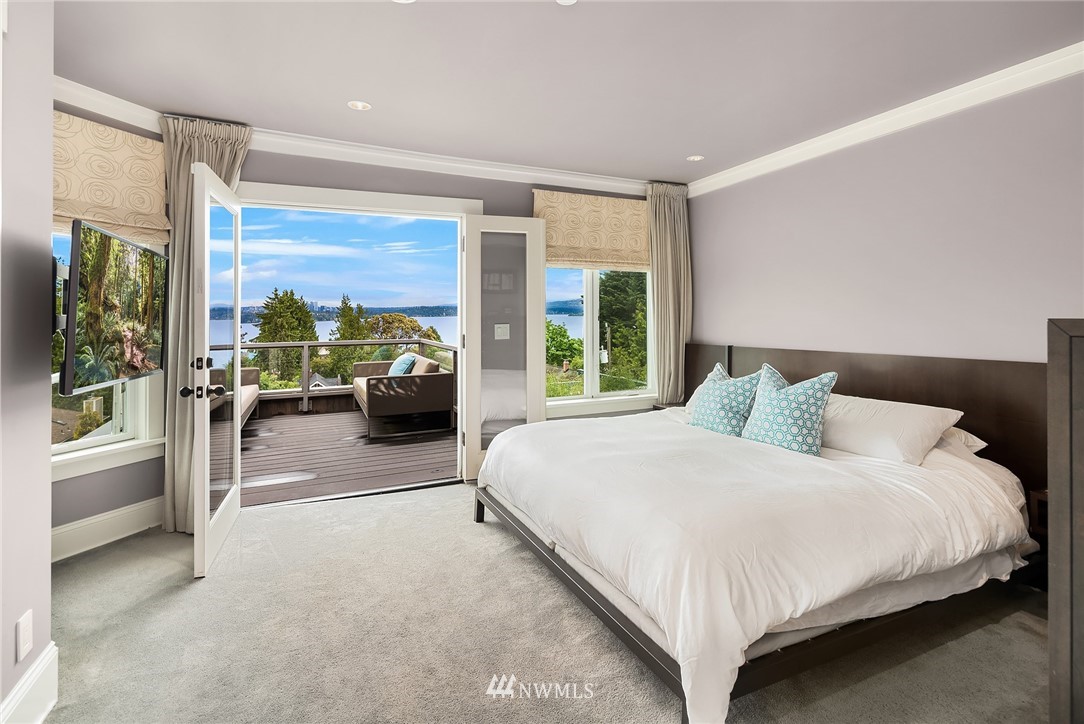 1618 37th Avenue Seattle, WA 98122 - Photo 15 of 39 a bedroom with a balcony a large bed and a large window