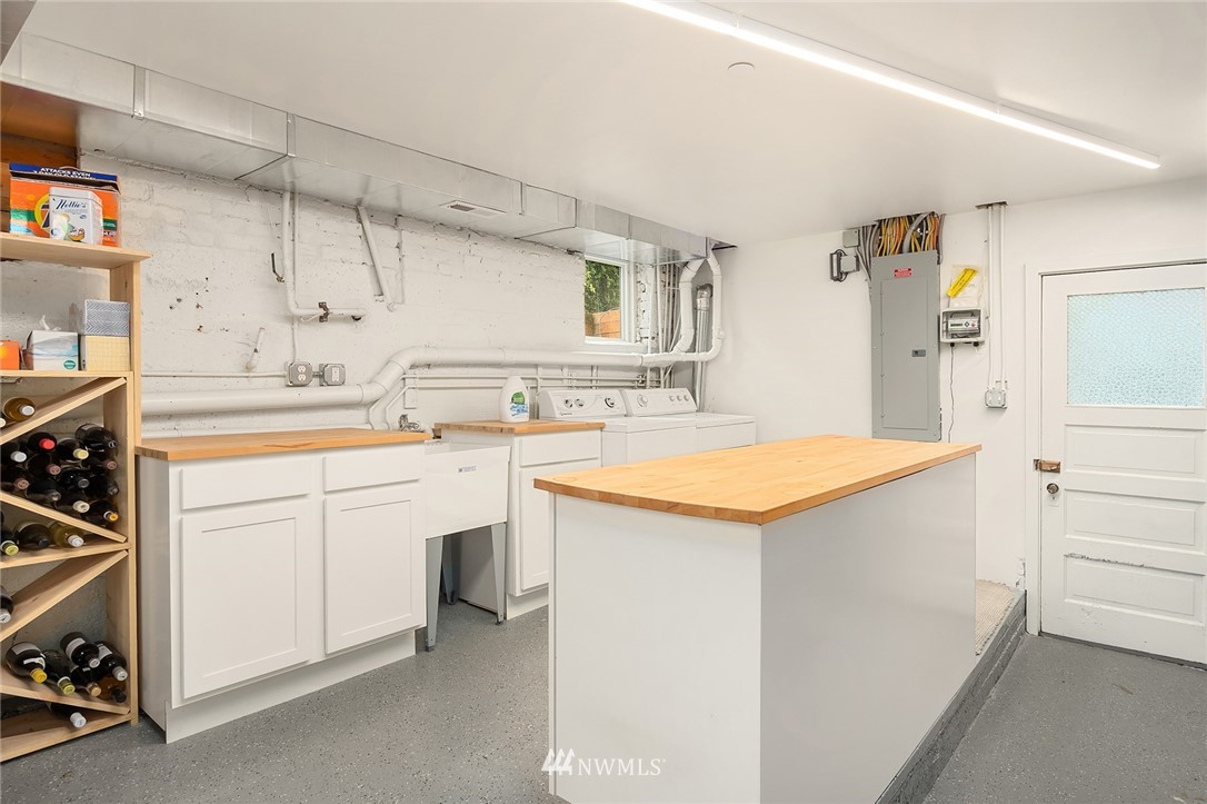 1618 37th Avenue Seattle, WA 98122 - Photo 25 of 39 a utility room with cabinets washer and dryer
