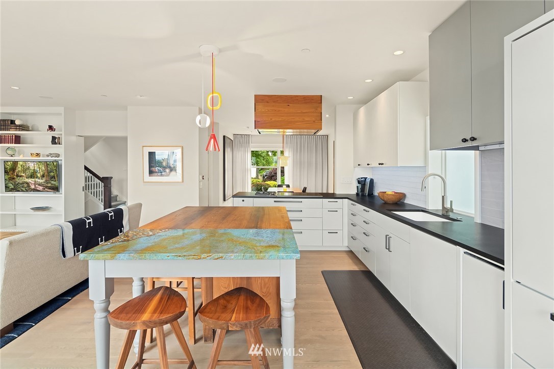 1618 37th Avenue Seattle, WA 98122 - Photo 7 of 39 a kitchen with stainless steel appliances kitchen island granite countertop a sink and cabinets