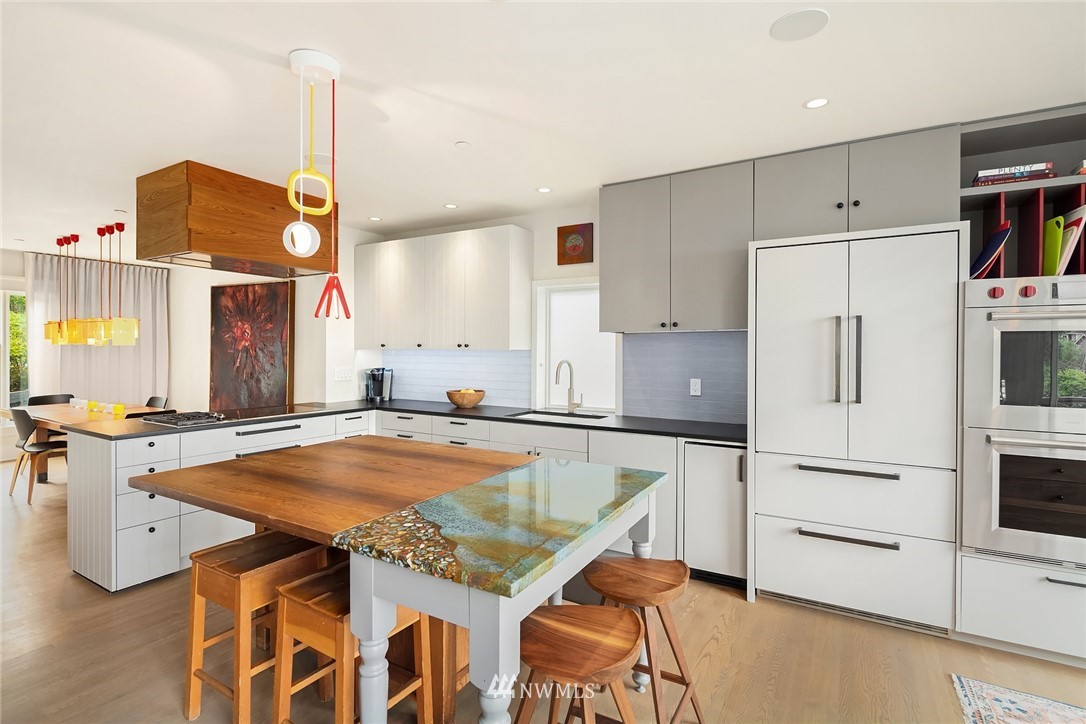 1618 37th Avenue Seattle, WA 98122 - Photo 8 of 39 a kitchen with a table chairs and a refrigerator