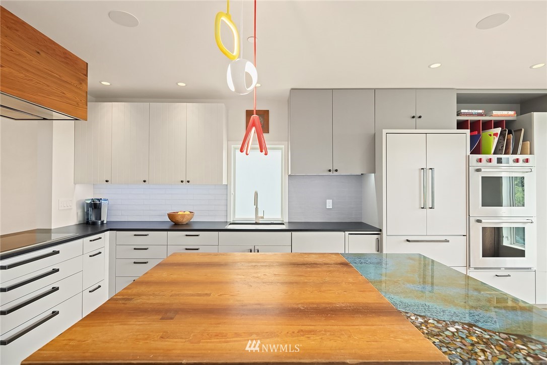 1618 37th Avenue Seattle, WA 98122 - Photo 9 of 39 a large white kitchen with stainless steel appliances granite countertop a sink and cabinets