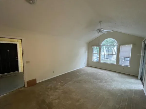a kitchen with refrigerator and white cabinets