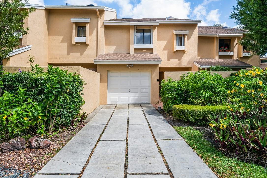 6535 Parkview Drive, Unit G Boca Raton, FL 33433 - Photo 1 of 27 a front view of a house with a garden