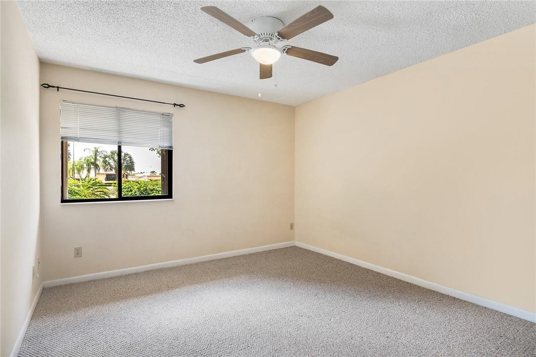 6535 Parkview Drive, Unit G Boca Raton, FL 33433 - Photo 12 of 27 an empty room with a window and a ceiling fan