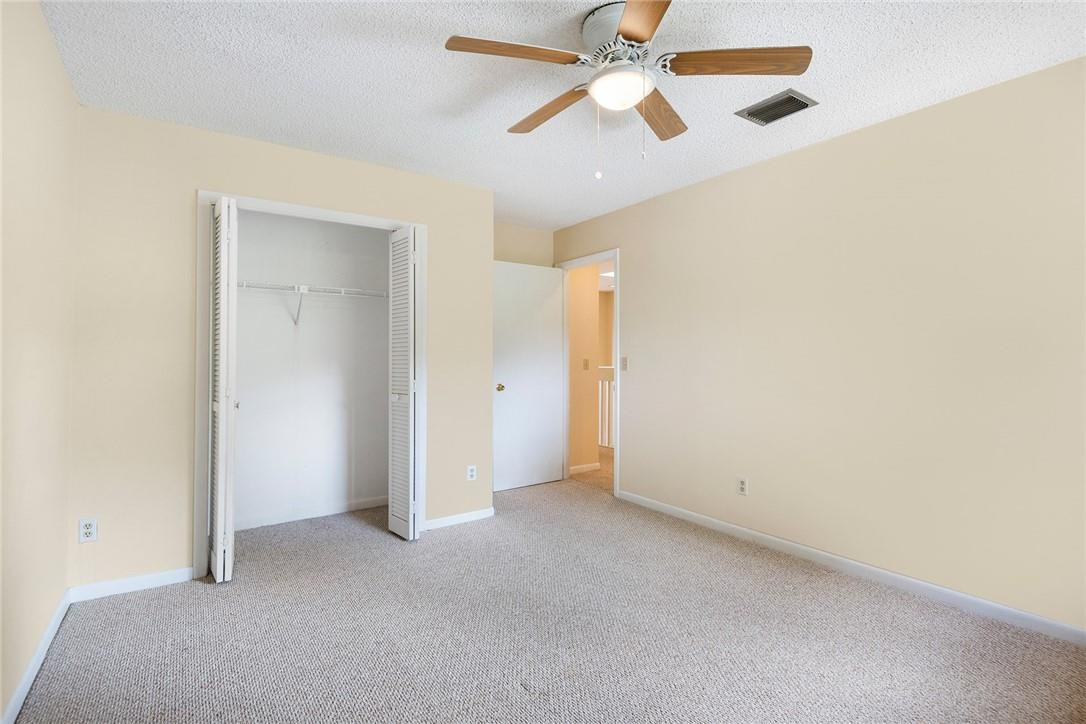 6535 Parkview Drive, Unit G Boca Raton, FL 33433 - Photo 13 of 27 an empty room with closet and a chandelier fan