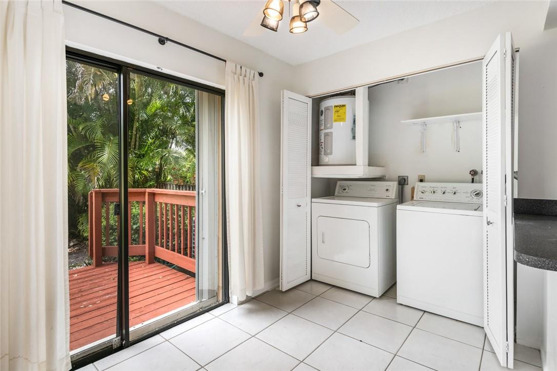 6535 Parkview Drive, Unit G Boca Raton, FL 33433 - Photo 6 of 27 a kitchen with white cabinets and white appliances