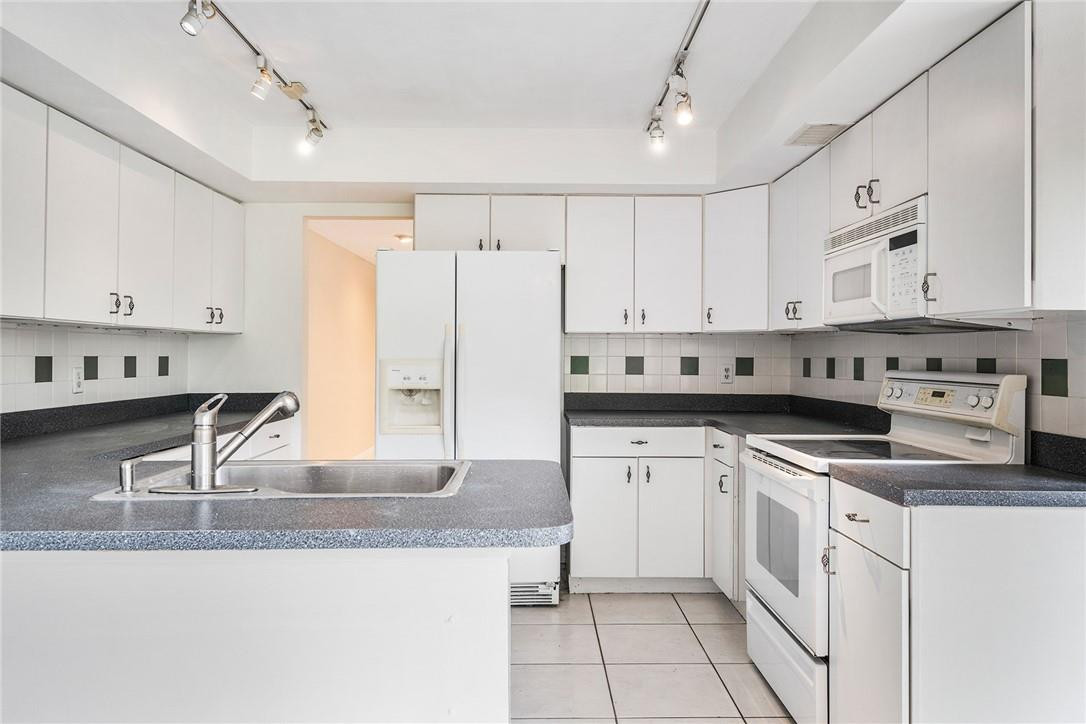 6535 Parkview Drive, Unit G Boca Raton, FL 33433 - Photo 7 of 27 a kitchen with stainless steel appliances granite countertop a sink and cabinets