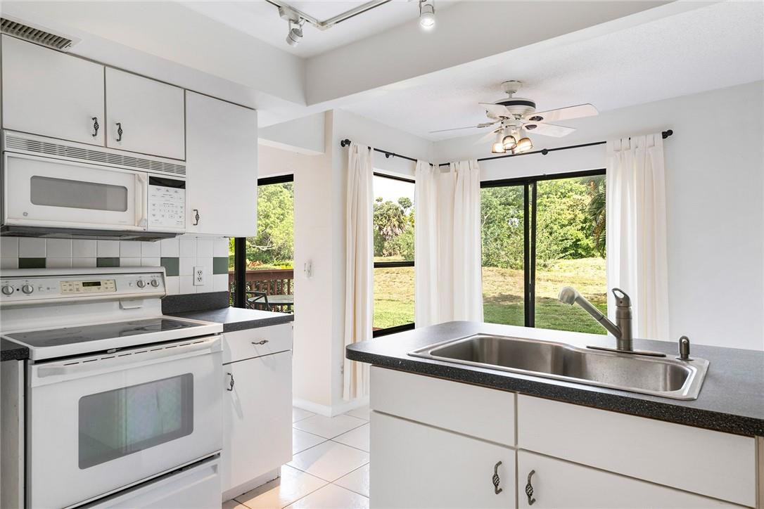 6535 Parkview Drive, Unit G Boca Raton, FL 33433 - Photo 8 of 27 a kitchen with stainless steel appliances a stove sink and cabinets